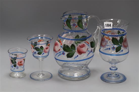 A hand painted decoration glass set consisting of a jug and three types of glass, French in origin tallest 23cm